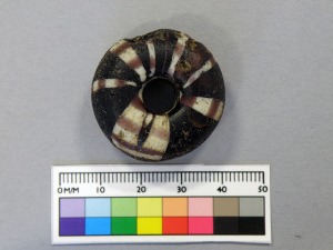 Figure 3: Annular bead made from translucent purple and opaque white glass. 